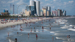 beach scene with ferris wheel and tallo buildings in Myrtle Beach